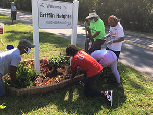 Residents help plant vegetation around Griffin Heights signage