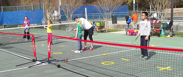 Young people learning to play tennis